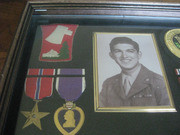 Enlarged Image of the Top-Left Section of the Framed Case With Acevedo's Military Honors, Awards, and Other Mementos