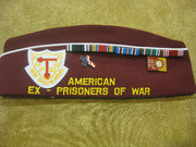 Gibbs' Side Cap With the Words American Ex-Prisoners of War With Patches and Pins Attached