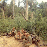 Photograph of Gustafsson and Fellow Soldiers Sitting and Eating in the Countryside of Vietnam