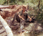 Photograph of Gustafsson Laying in A Vietnamese Ammo Bandolier