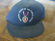 A Dark Blue Baseball Cap With the inscription Military Order of the Purple Heart and Its Logo