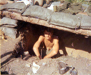 Photograph of Gustafsson Sitting in A Foxhole