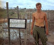 Photograph of Gustafsson Next To A Sign Noting A Landing Zone Entitled, Jamie