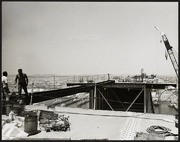 Atop Bridge Showing Steel Framing, Roadway Surface, and Workers