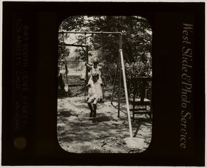 Two children playing on swing set, Evangelical kindergarten, Cebu, Philippines, 1934