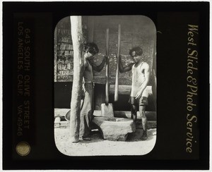 Boys pounding rice, Masbate, Philippines, 1932