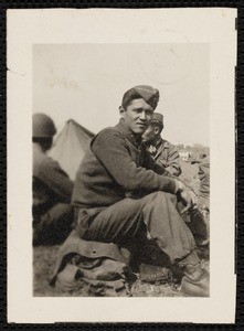 Sugiyama sitting on knapsack with other soldiers