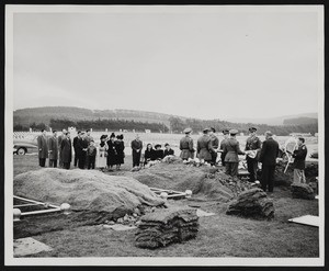 Officers draping flag over casket, 1948-12-15