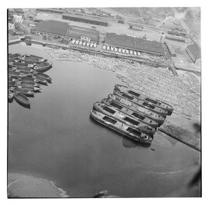 Aerial view of harbor with empty boats and floating logs, South Korea