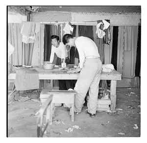 Tailors working at a table outside, South Korea 1956-59