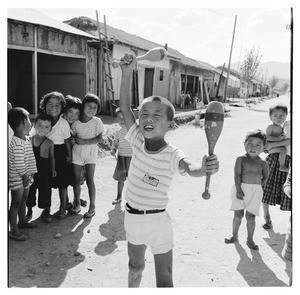 Boy holding juggling pins, Korea