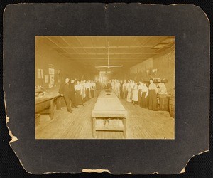 About thirty persons inside a manufacturing plant, cabinet photograph, circa 1900s