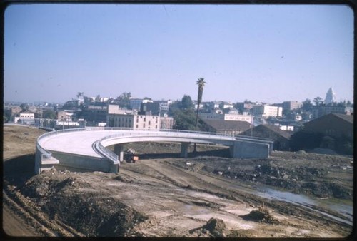 Freeway interchange ramp; Los Angeles City Hall in background