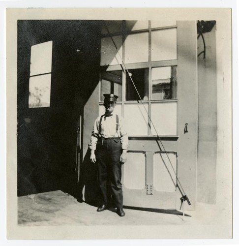 Fire fighter in front of fire house, Los Angeles