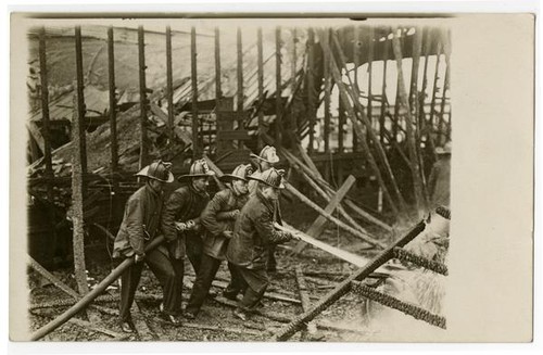 Fire fighters of Engine Co. No. 9 fighting fire, building exterior, Los Angeles