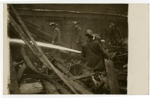 Fire fighters of Engine Co. No. 9 fighting fire, building exterior, Los Angeles