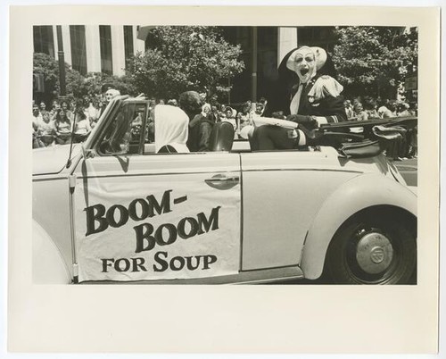 Sister Boom Boom in a convertible with sign that reads: "Boom-Boom for Soup"