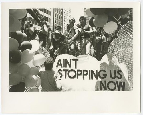 People gathered on float with sign: Ain't No Stopping Us Now