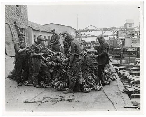 Fishermen mending fish nets, East San Pedro, Los Angeles Harbor district