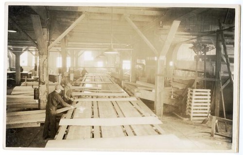 Men working with sheets of veneer, California