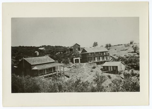 Scene of buildings with lumber in yard, later 1890s