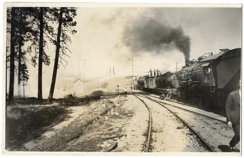 Fire suppression, men spraying water from the top of a railroad car, California