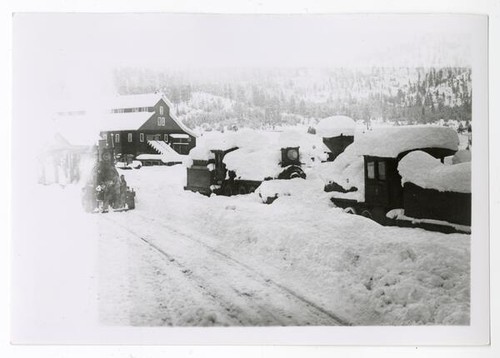 Winter scene with snow-covered engines and train tracks