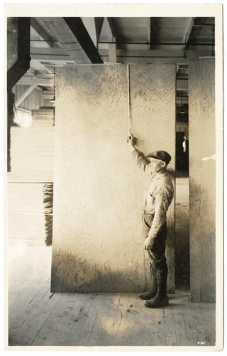 R-62 [Man measuring a piece of lumber]