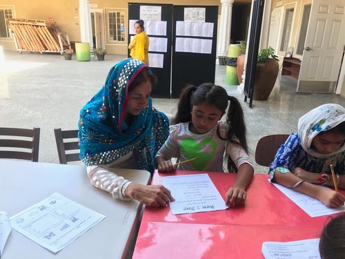 Pushpinder Kaur with Blue Scarf Teaching one Girl Student