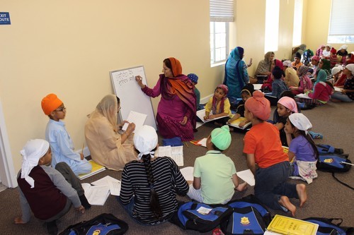 Pushpinder Kaur Teaching Students on a Whiteboard at San Jose Khalsa School