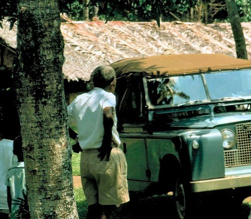 Abel stands in front of a Land Rover