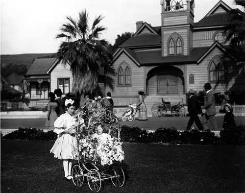 Girl and Baby in Decorated Stroller