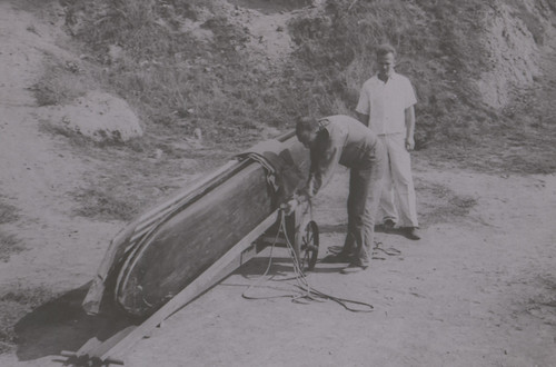 Wimpy and Herb Loading Surfboards on Cart