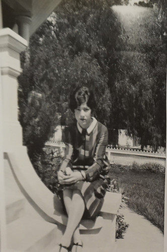 Young Woman Sitting on Porch Railing