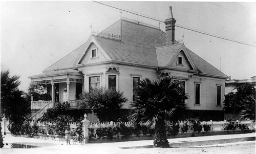 Peirano House with People on Porch and Sidewalk