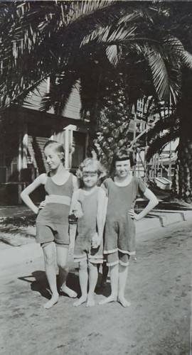 Three Girls in Swim Suits on Palm Tree Lined Street