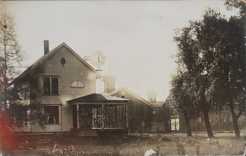 Exterior Home with Farm Buildings and Windmill