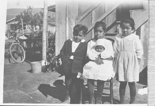 Portrait of Three Children and a Baby