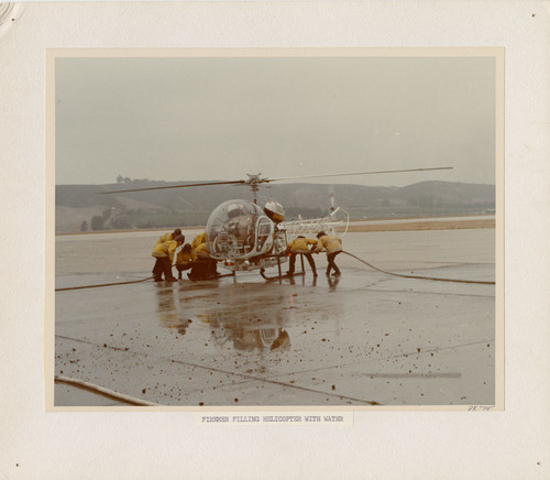 Firefighters Filling Helicopter with Water