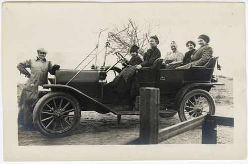 Women and a Boy in an Open Car