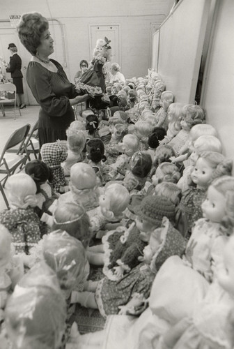 Magda Locano Admiring Dolls