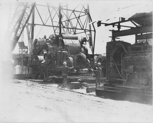Men Installing Oil Drilling Equipment