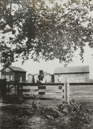 Two Men by Farm Fence