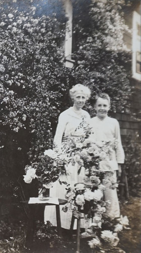 Mrs. E.W. Daily in Rose Garden with Boy