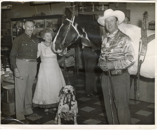 Max and Ruth Riave in their Store, Along With a Horse and Dog