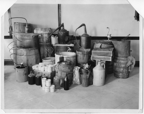 Sheriff's Raid--Casks, Bottles, Tubes to Make Booze