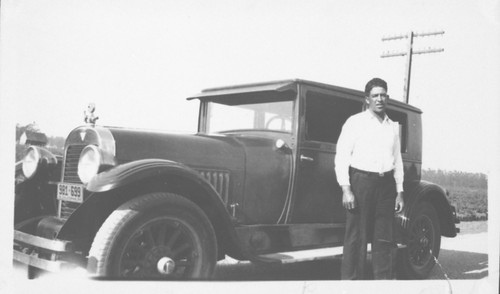 Ventura Valencia Posing with Automobile