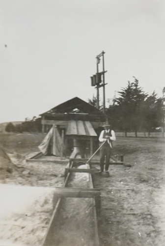 E. W. Daily Standing by Wooden Water Shed