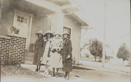 Four Women in Front of House