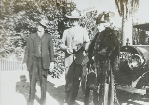 E.W. Daily, Man, and Woman Standing in front of Automobile